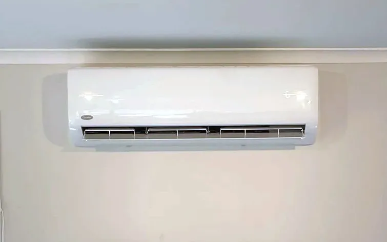 A heat pump we fitted high on a living room wall.
